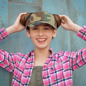 Girl wearing hand-tailored camouflage women’s baseball cap with scrunchies for space buns and pigtails hairstyles 