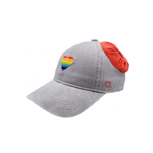 Load image into Gallery viewer,  Hand-tailored Rainbow Heart on charcoal women’s baseball cap with red scrunchies for space buns and pigtails hairstyles 